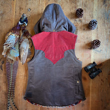 Custom waxed canvas vest with western style yoke and detachable hood.
